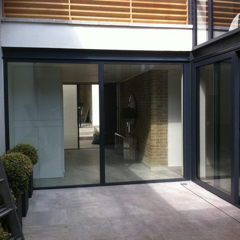 Floor-to-ceiling sliding doors opening to courtyard in Tottenham