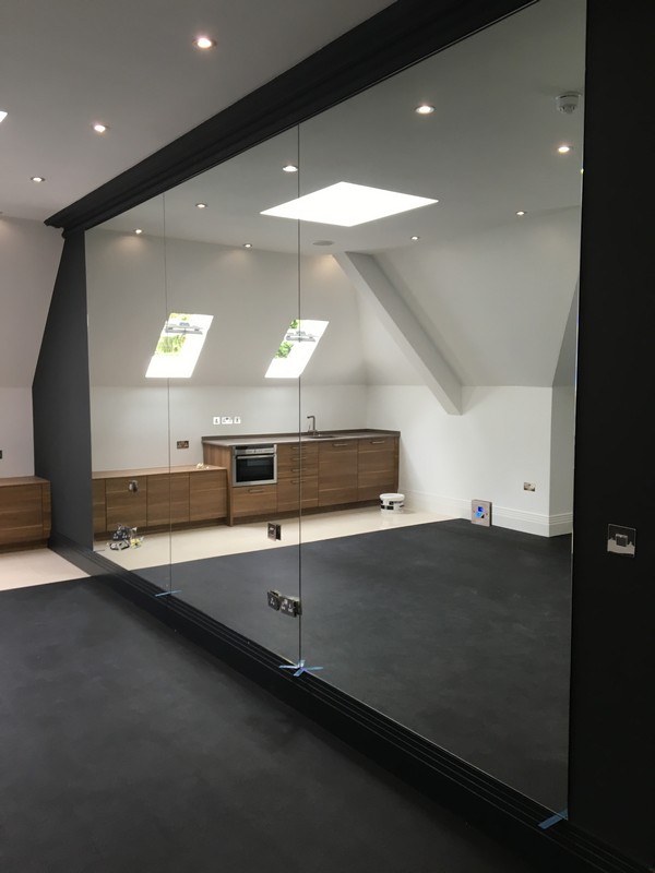 Frameless glass partition in loft conversion by Tottenham glaziers