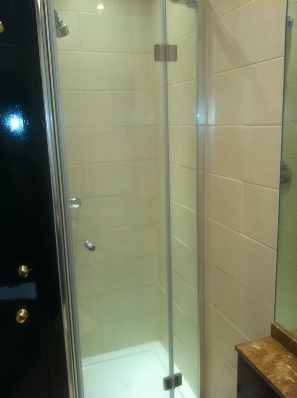 Frameless glass shower enclosure with chrome fittings in Tottenham