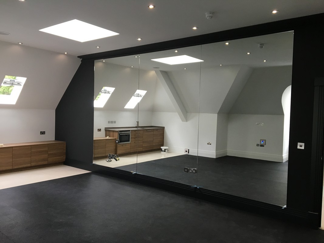 Frameless glass wall dividing loft conversion in Tottenham