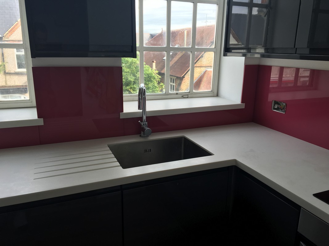 Deep plum coloured glass splashback in modern Tottenham kitchen