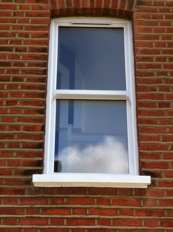 uPVC sash window on Victorian red brick house in Tottenham